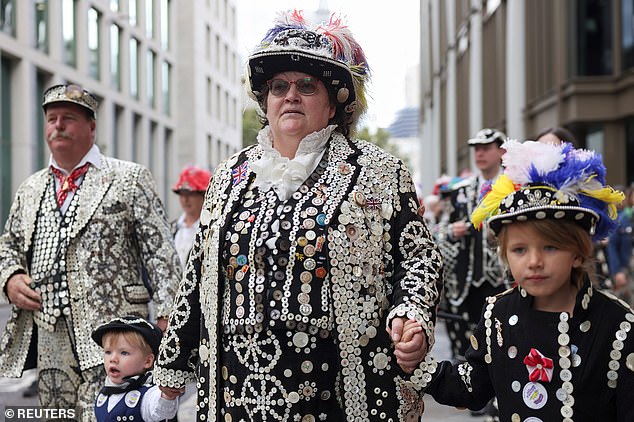 Paula Hemsley, Pearly Queen of Harrow walked with her grandchildren during the festival