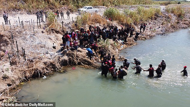 National Guard in boats and airboats and barbed wire along the banks try to discourage migrants from crossing the Rio Grand and entering the US on September 23