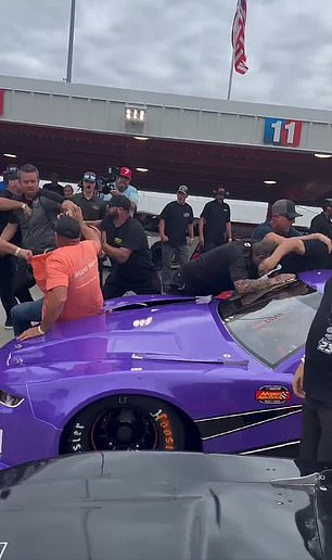 The hood of a racing car was completely stuck after two men pushed it