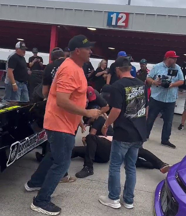 Video also shows a man being pushed or punched to the ground after qualifying race No. 2