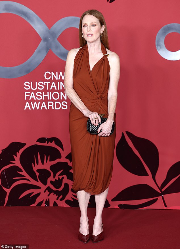 Glamorous: Actress Julianne, 62, looked stunning in a brown halter-neck midi dress with a fitted knot at the waist