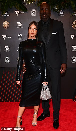 Gold Coast Suns star Mabior Chol's girlfriend Lauren Harris favored a long-sleeved latex-style dress that highlighted her phenomenal figure but didn't do much to make her stand out from the crowd