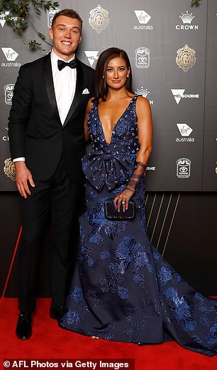 The Blues' Patrick Cripps and Monique Fontana posed on the red carpet, but Monique's navy blue dress with a v-neck and a large bow at the front (as well as a train) had way too much going for it and was distracting to the eye