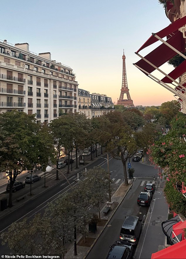 Stunning view: She also shared a photo overlooking the Parisian street with the Eiffel Tower in the distance, surrounded by a pastel sunset sky