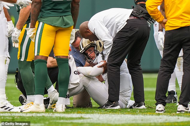 Quarterback Derek Carr #4 of the New Orleans Saints stands up slowly after a hit