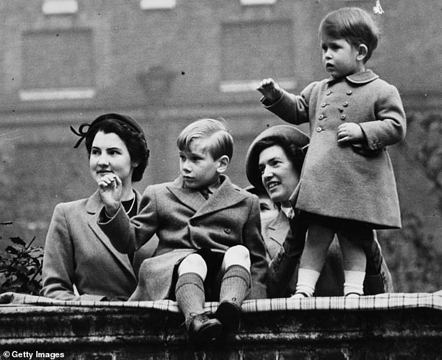 Prince Charles, standing, with nanny Helen Lightbody at his side and cousin Prince Richard of Gloucester with his nanny.  They stand outside Clarence House in 1951