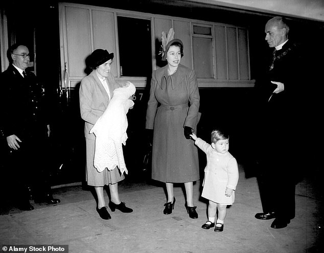 The Queen holds Charles tightly by the hand as Helen Lightbody carries Princess Anne