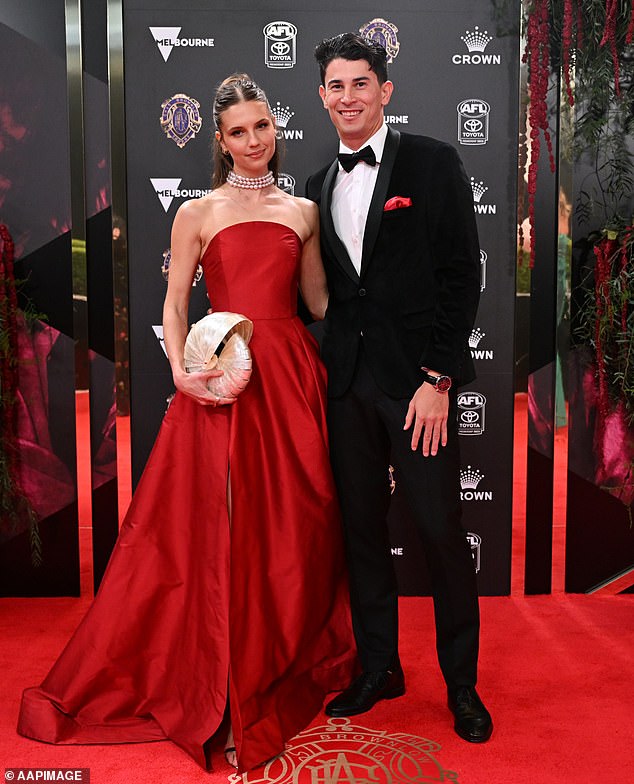 Fremantle player Bailey Banfield had the beautiful Julia Edwards on his arm, with the AFL star opting for a black tuxedo with a red pocket square to match his date's dress