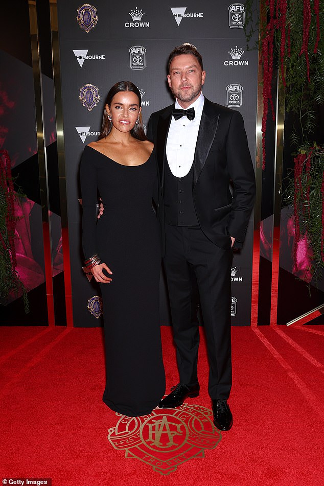 AFL head of corporate affairs Jay Allen looked dapper in his fitted suit, while his partner chose a simply chic, flowing black dress