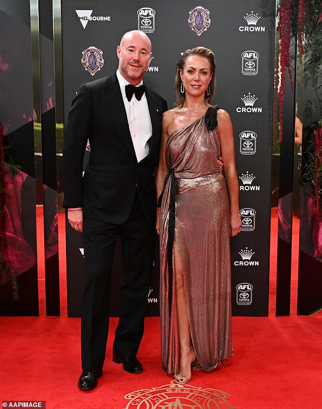 Carlton Football Club president Luke Sayers had his wife Cate Sayer on his arm as Cate glittered in a slinky bronze gown