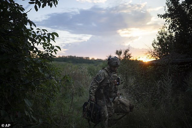 A Ukrainian soldier from the elite drone unit packs his belongings after an attack on the front line on the outskirts of Kremmina, Ukraine, August 20