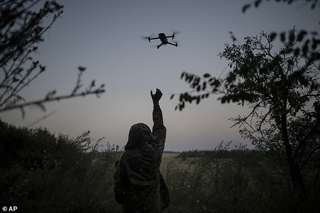 A Ukrainian drone pilot reaches for a reconnaissance drone in the Luhansk region