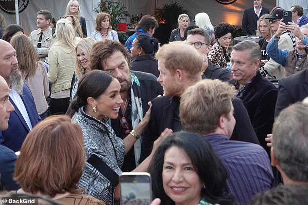 Meghan chats animatedly with other guests during the fundraiser