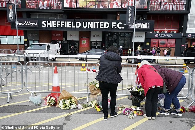 Floral tributes in club colors were left by well-wishers in memory of Maddy at the Blades ground