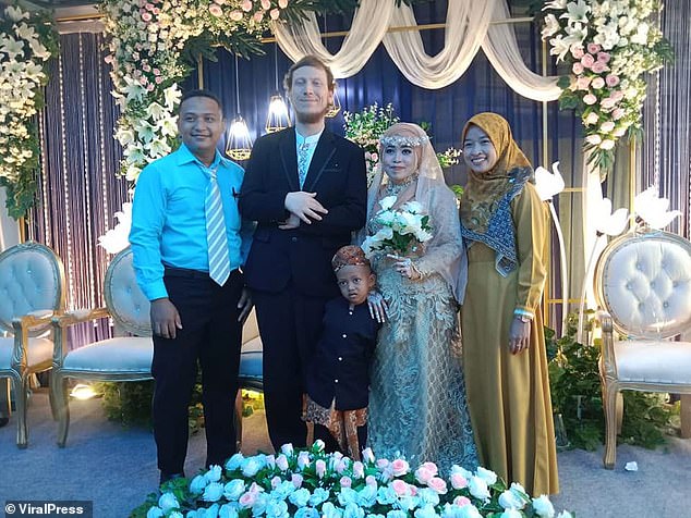 Welohr is seen next to his Indonesian wife and family