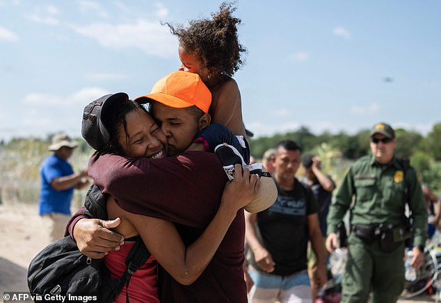 A migrant family from Venezuela reacts after breaking through a barbed wire barricade into the US.  They say they are fleeing hunger and repression under Nicolas Maduro's regime