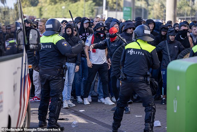 Baton-wielding riot police confront Ajax fans after Sunday's abandoned league match