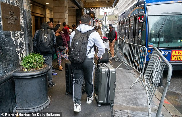 Migrants arrive at the Roosevelt Hotel in Manhattan on Monday.  The historic building is being dubbed “the new Ellis Island” by city officials