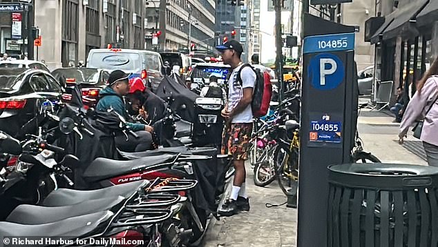 Scooters parked outside the Roosevelt Hotel.  Many of the asylum seekers work illegally as delivery drivers in Manhattan – some boast of making up to $3,000 a month