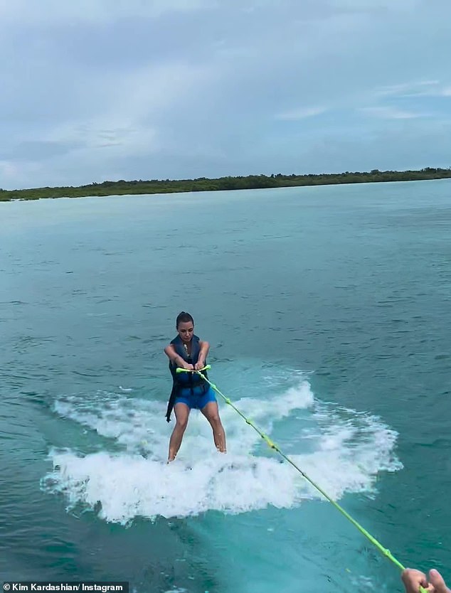 Strong girl: In a clip posted to the makeup mogul's Instagram on Monday, Kim showed off her athletic skills by expertly maneuvering around on the wakeboard