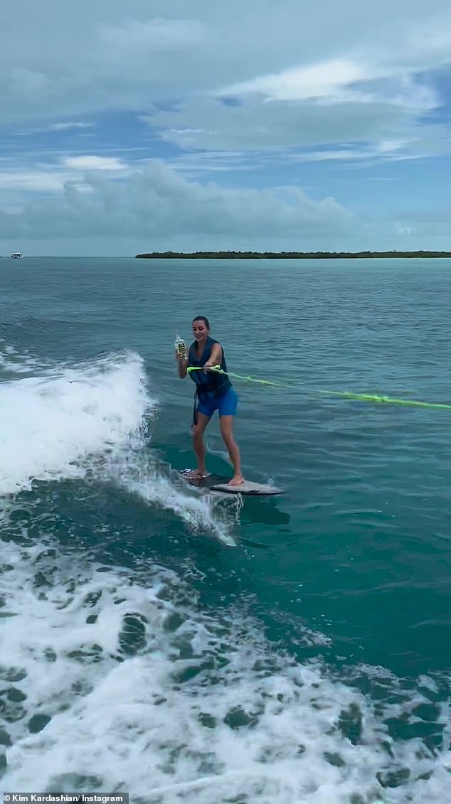 Take a shot?  The mother of four proudly held up her sibling's famous tequila while wakeboarding