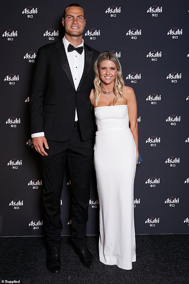 Jarrod Witts beamed next to his partner Renee, who wore a white strapless dress