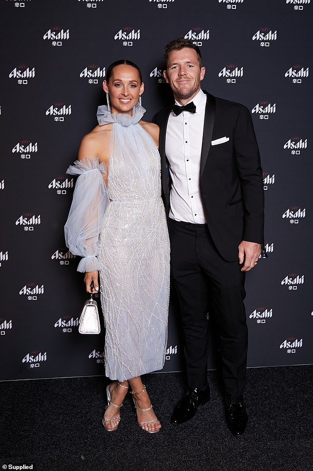 Swans star Luke Parker's wife Kate Lawrence-Parker was the center of attention in a playful baby blue dress with white beading and layered sheer fabric on the sleeves