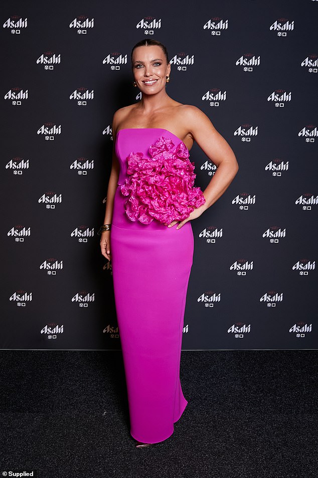 Abbey Holmes was a pretty pink, with the AFL player choosing a Barbie-inspired candy shade for her strapless, figure-hugging gown with a large floral embellishment