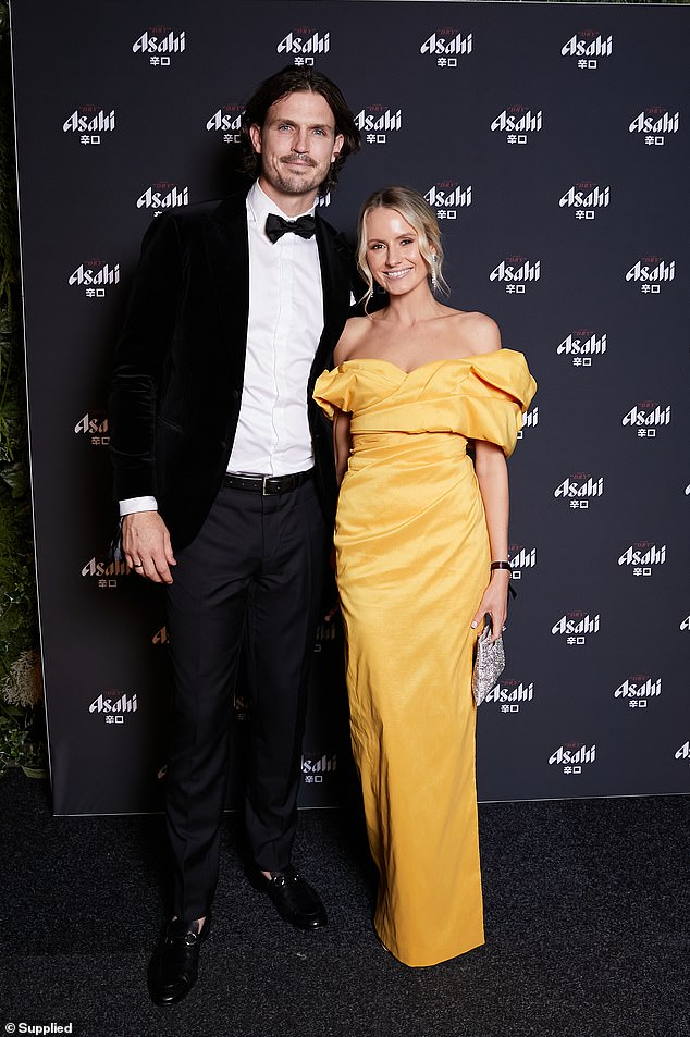 Phil Davis and wife Greta Davis were all smiles as Greta rocked a bright orange off-the-shoulder dress