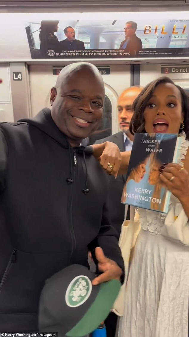 Kerry and fans: The video – set to The King Khan and BBQ Show's Love You So – showed Washington in a sleeveless white dress with ruffles walking through the F train station handing out books to fans