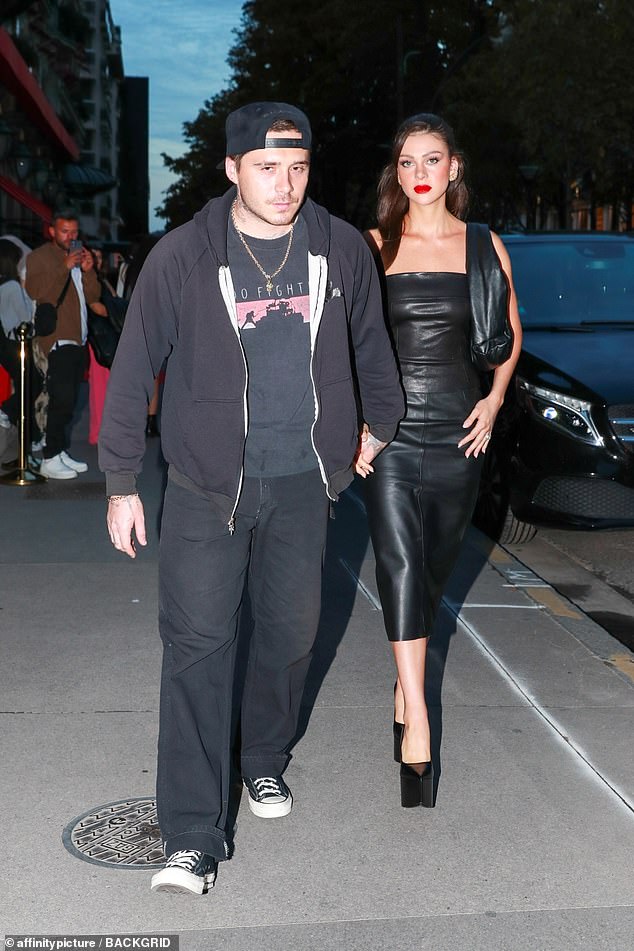 Sweet: The loving couple held hands as they walked through the streets of the French capital