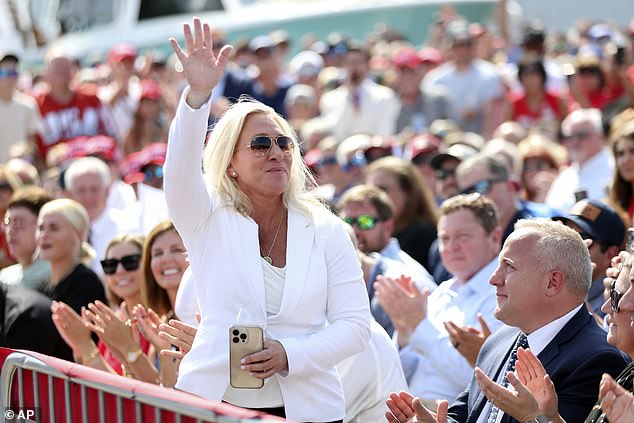 Trump supporter Marjorie Taylor Greene waves to the crowd at the ex-president's rally in Summerville, South Carolina, on Monday