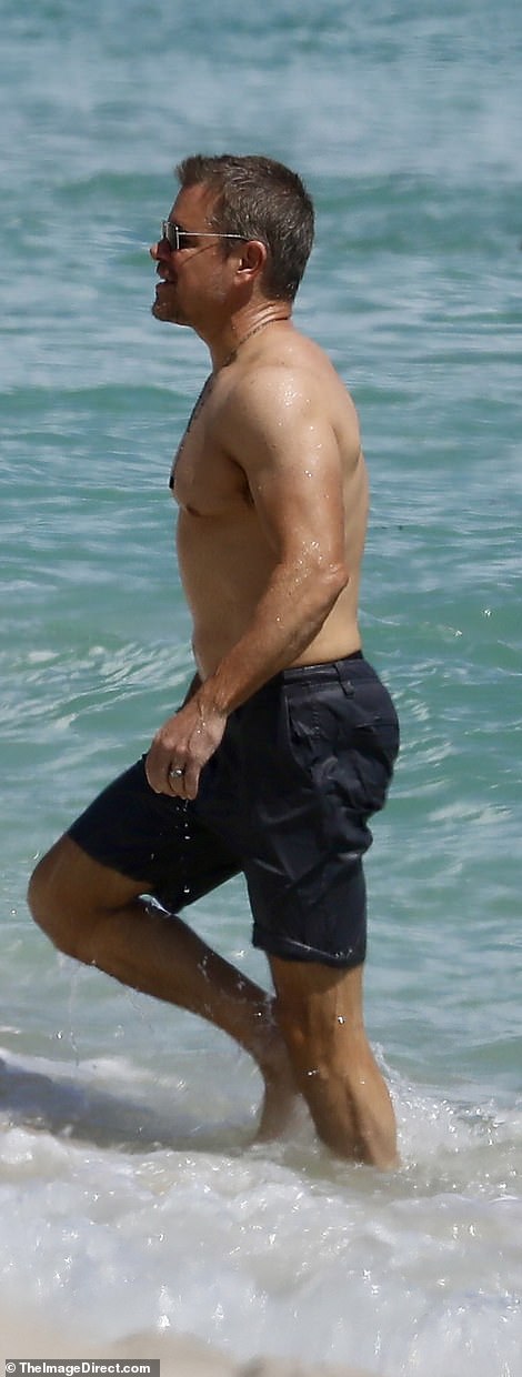 Fit: The Oscar winner looked fit as he swam shirtless in the warm water in gray knee-length swim trunks