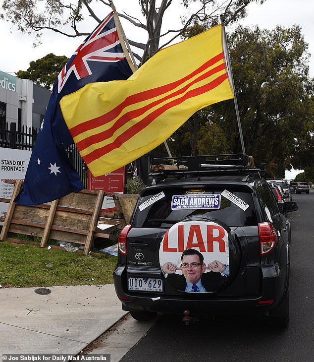 A professional Ian Cook car parked outside the Mulgrave voting centre, labeling Dan Andrews a 'liar' and showing him with his fingers in his ears