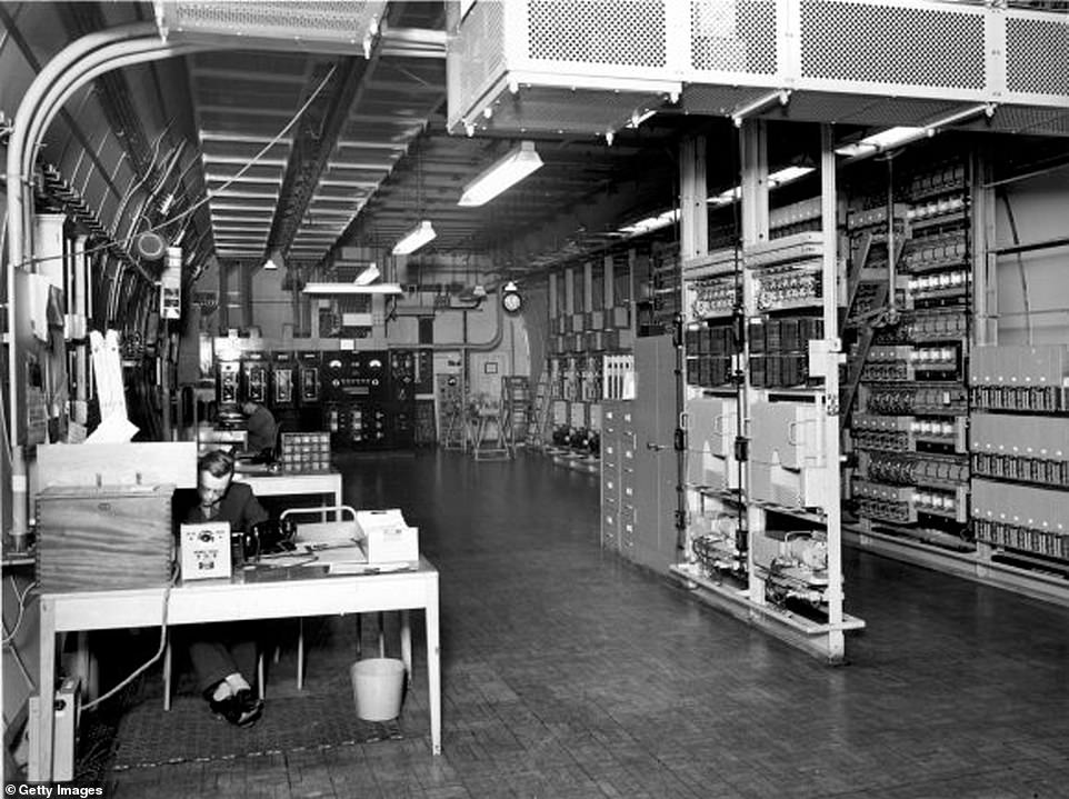 Operators work on the power equipment and central equipment racks at the Kingsway Tunnel power station in January 1957