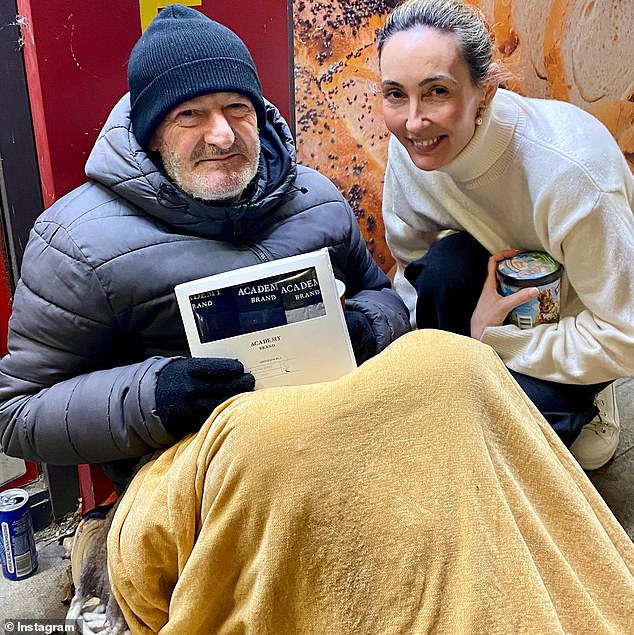 Pass It On Clothing has provided more than 250,000 new items of clothing to the homeless since 2016.  In the photo: co-founder Olga Puga gives new underwear to a homeless man