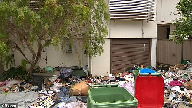 An abandoned house (pictured) in Southport in southeast Queensland is buried among piles of rubbish scattered across the property's front garden, forcing police to intervene after squatters were spotted at the property