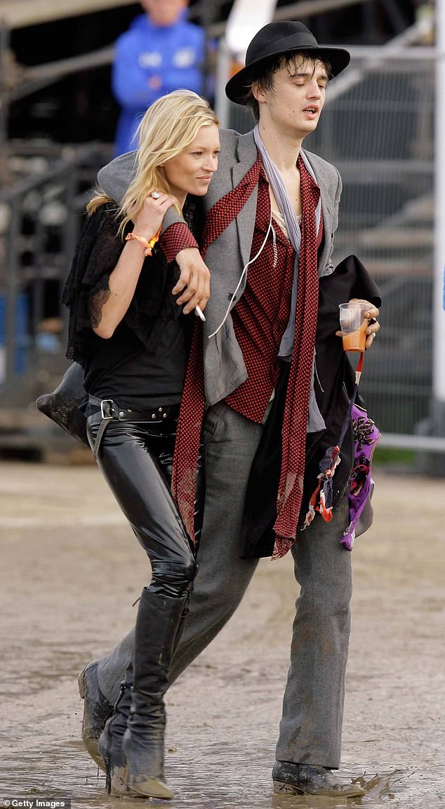 Doherty was Kate Moss's on-and-off boyfriend at the time.  They can be seen at Glastonbury in 2007