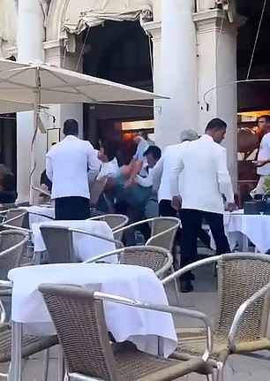 Local media reported that some waiters pushed away one of the 'foreign customers' after a heated argument (photo)