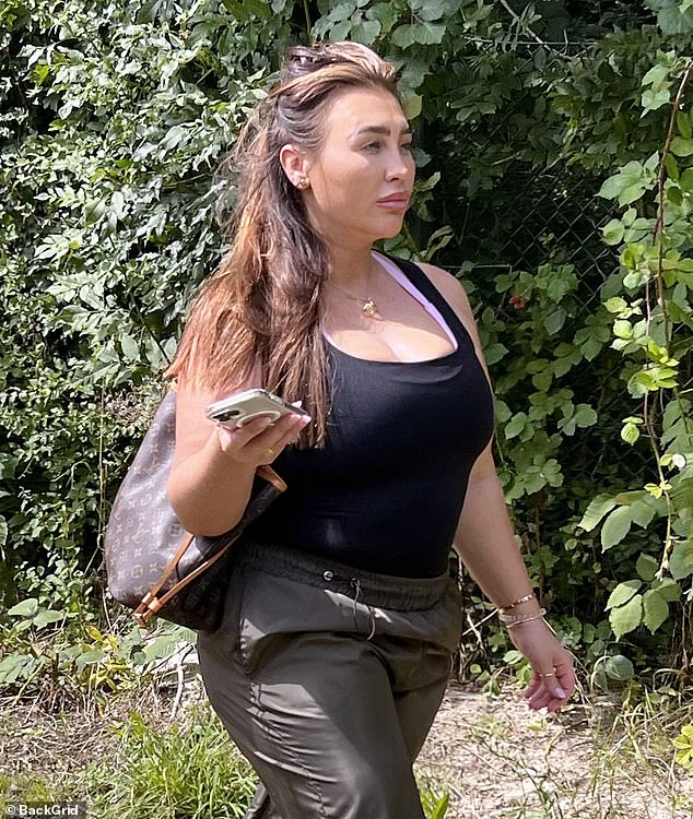 Casual: The former TOWIE star, 36, cuts a relaxed figure in a black tank top and dark green combat trousers