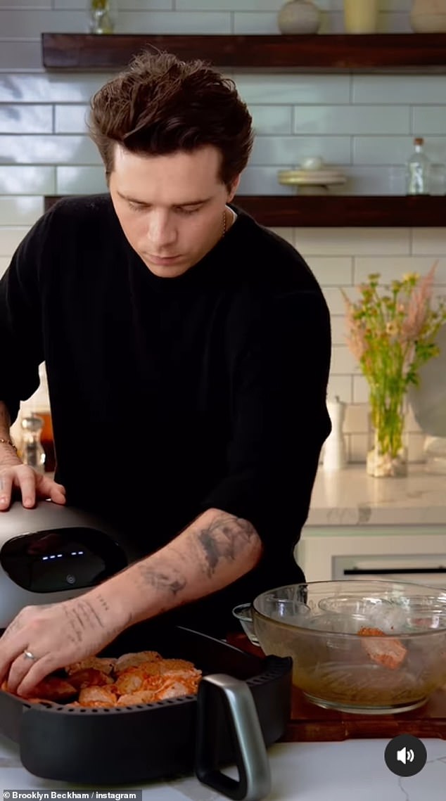 Skills: The 24-year-old was dressed in a black knit sweater as he cooked a simple chicken wing recipe in the Typhur Air Fryer