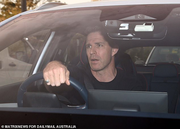 Mason's fiancée Todd Liubinskas (pictured) appeared somber as he waited in traffic on Tuesday