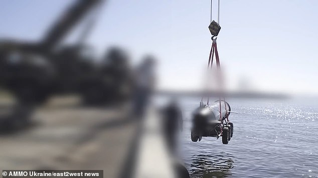 The 6 meter long kamikaze sea drone 'Marichka' is lowered into the sea for tests