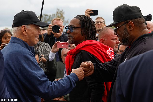 President Biden bumps fists with a striking autoworker