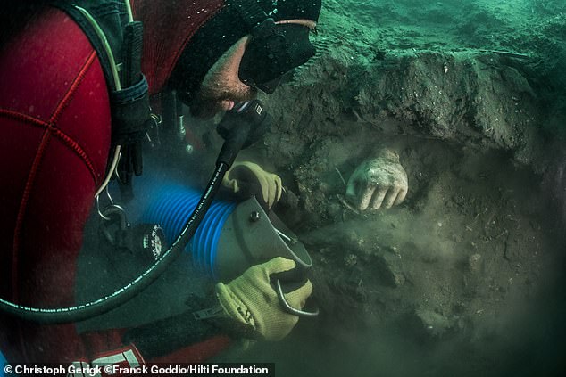 A hand emerges from the sediment during an archaeological dig in Heracleion.  It dates from the 5th century BC and early 4th century BC, probably from Cyprus