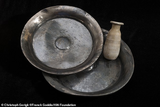 Two silver ritual bowls for libations to the gods from the temple treasury.  Silver was considered extremely valuable in ancient Egypt.  An alabaster container for ointments and perfumes was found among them