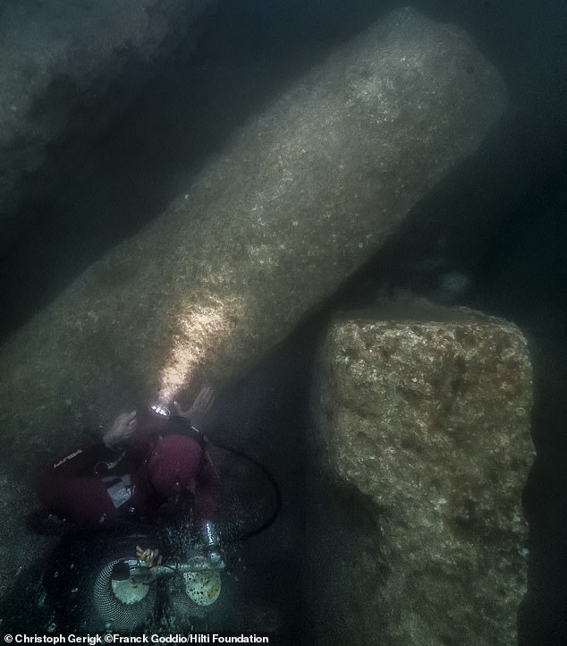 After the excavation, an archaeological diver stares at the huge blocks of the Amun Temple, which fell into Heracleion's southern canal in the mid-second century BC.  They were discovered under about 3 meters of hard clay