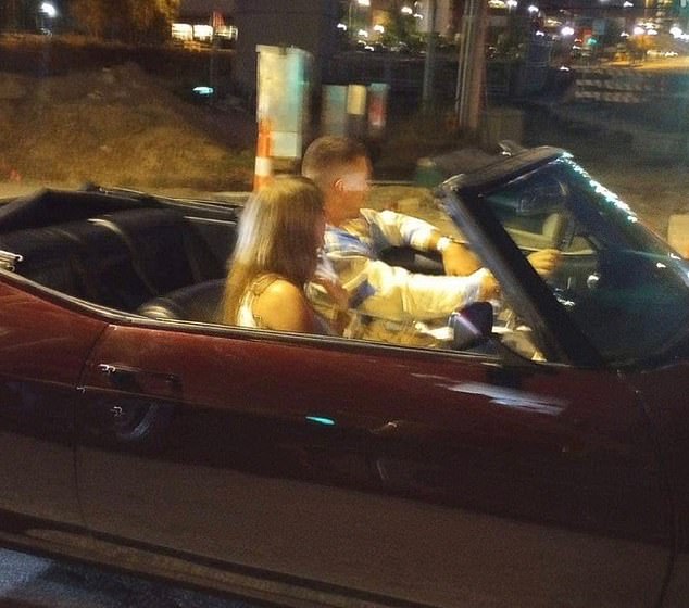 The hot new item appeared to drive away in Travis' vintage convertible after Sunday's game