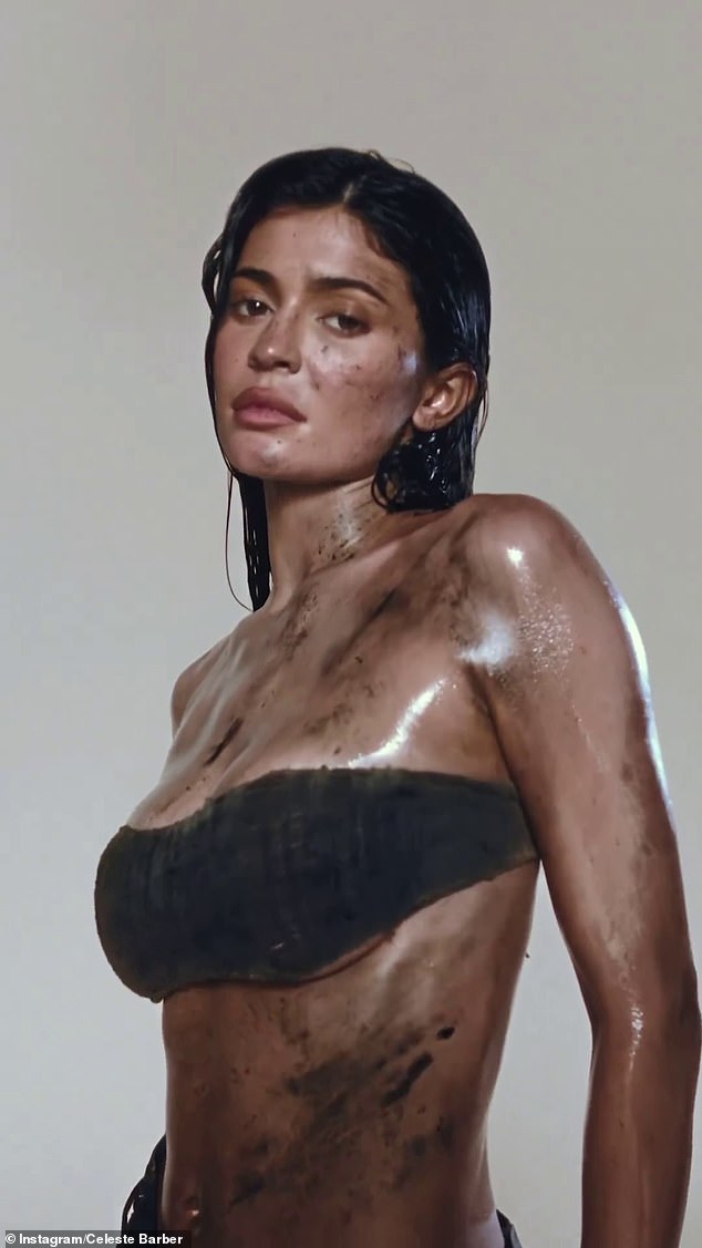 In the original clip, a dirt-stained Kylie is seen posing in front of a white background, wearing a crop top and low-slung skirt as she stares moodily into the camera.