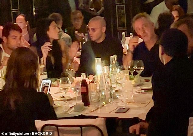 Casual: Leonardo, 48, made a typically understated appearance, ducking into Hotel Costes wearing a black jacket and baseball cap (right) as he dined with Vittoria and friends